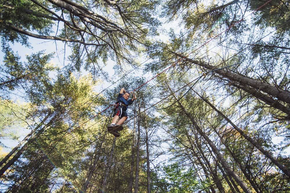 boy looking down crossing tight rope
