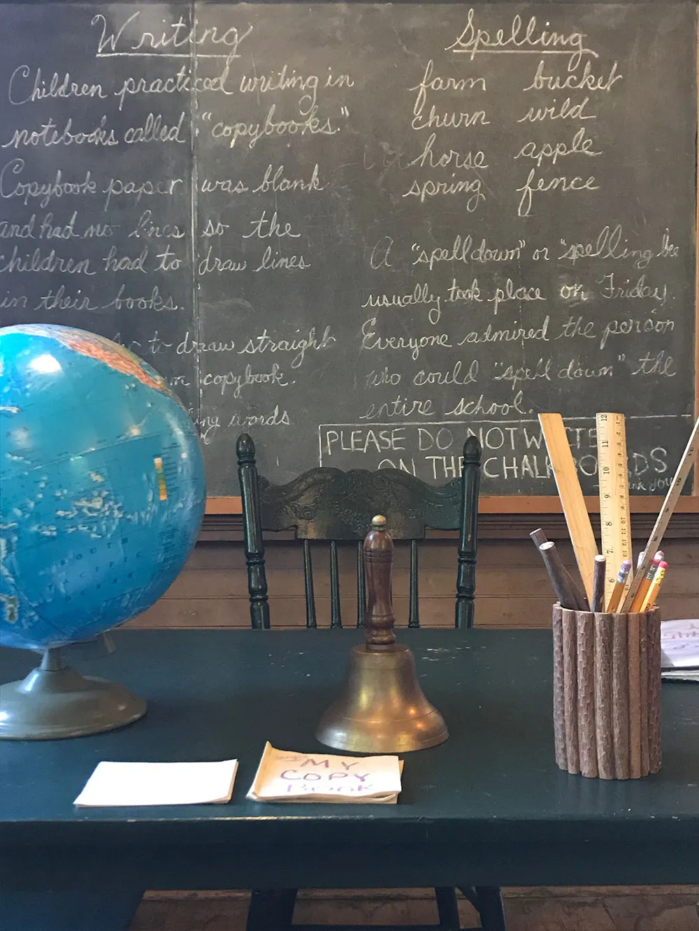 teachers desk in front of blackboard